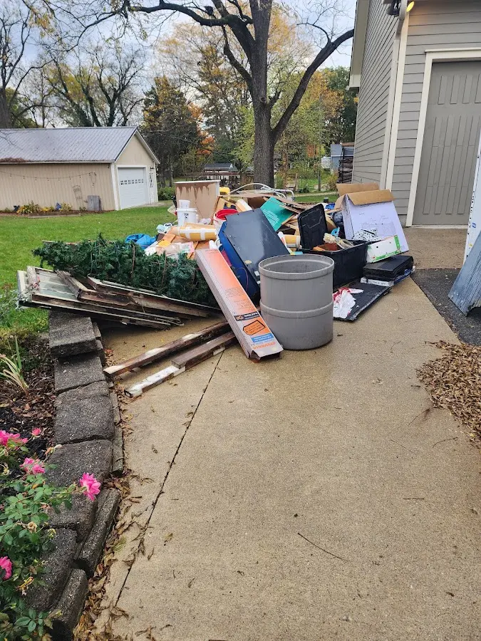 Dumpster being loaded with debris for Roofing Dumpster Rental in East Troy